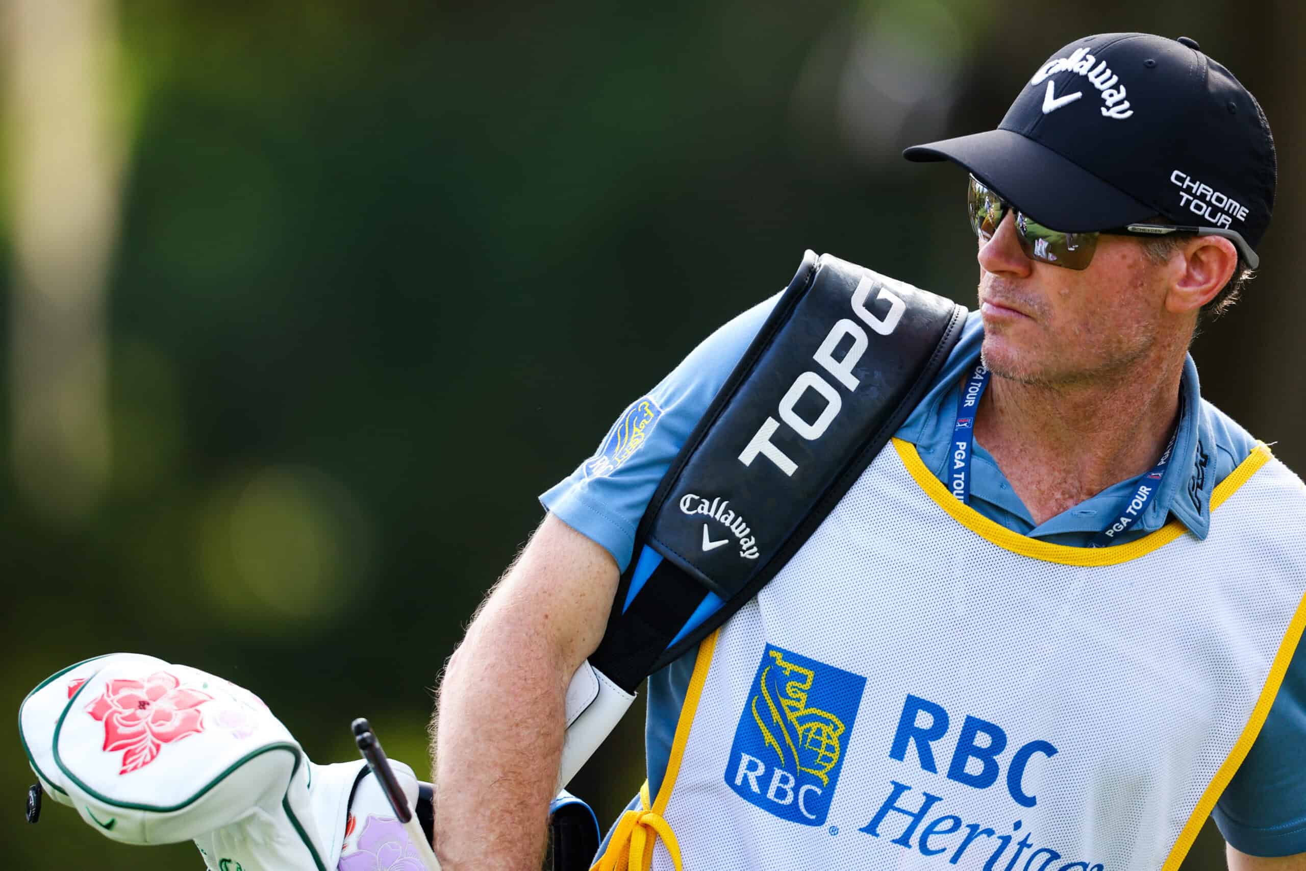 HILTON HEAD ISLAND, SOUTH CAROLINA - APRIL 18: Travis Perkins, caddie for Sam Burns, walks the third hole during the first round of the RBC Heritage at Harbour Town Golf Links on April 18, 2024 in Hilton Head Island, South Carolina. (Photo by Andrew Redington/Getty Images)